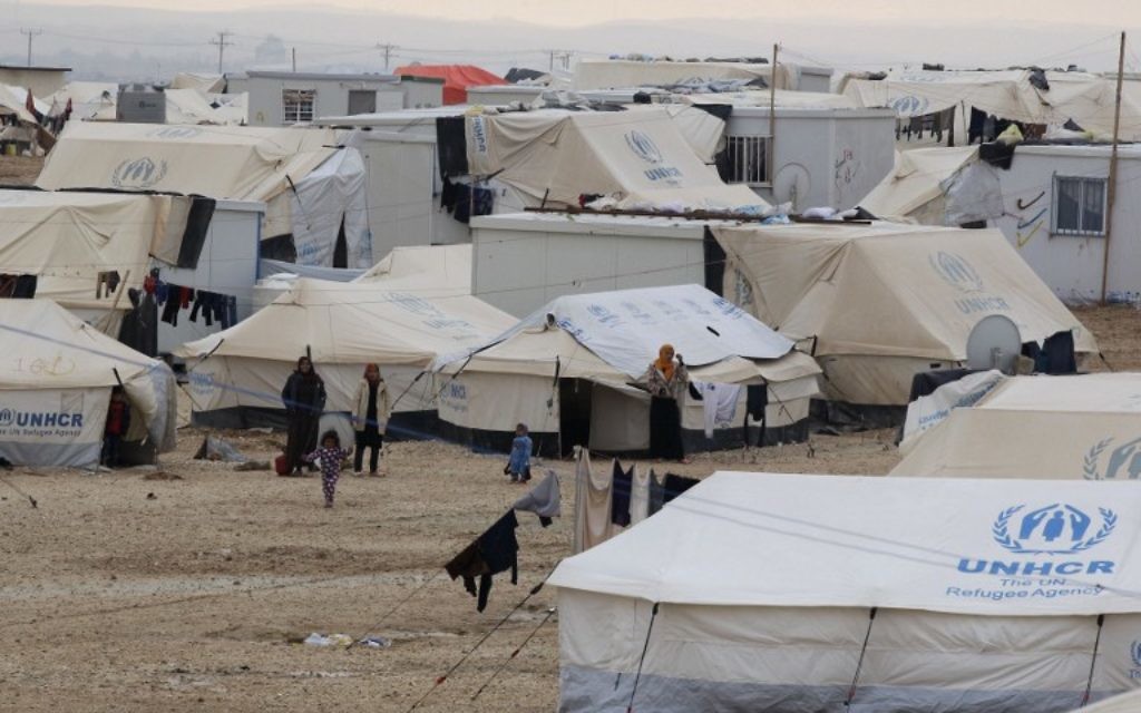 Photo d'illustration : Photo prise le 11 janvier 2015, montrant des réfugiés syriens debout à côté de tentes de l'ONU au camp de réfugiés de Zaatari, au nord est de la capitale jordanienne Amman. Plus d'1,1 millions de Syriens ont  passé la frontière vers le Liban et environ 600 000 sont en Jordanie, selon le HCR, le 28 août 2015. Amman avance le chiffre de 1,4 million, soit 20 % de la population du royaume qui est pauvre en ressource (Crédit : AFP PHOTO / KHALIL MAZRAAWI)