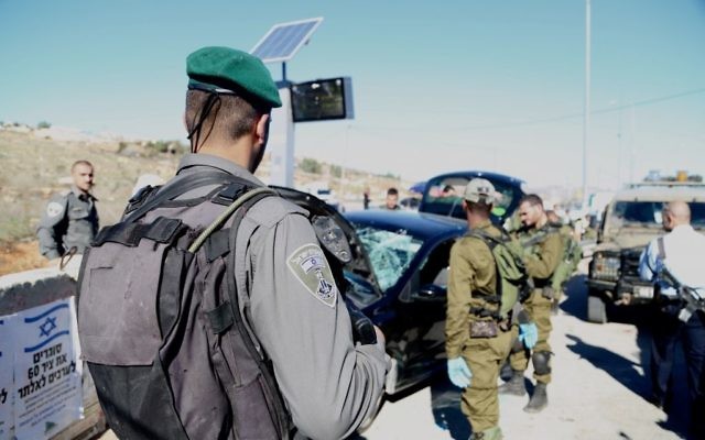 Garde-frontières et soldats israéliens sur les lieux d'une attaque à la voiture bélier au carrefour Tapuah, en Cisjordanie, le 24 novembre 2015. (Crédit : police israélienne)