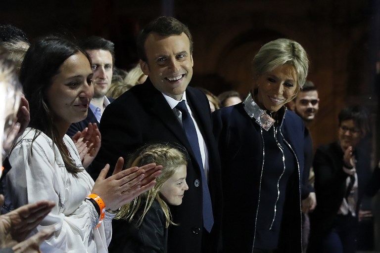 Emmanuel Macron, élu à la présidence de la République française, au centre, et son épouse Brigitte, devant la pyramide du Louvre, le 7 mai 2017. (Crédit : Thomas Samson/Pool/AFP)