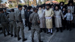 Les forces de sécurité israéliennes montent la garde pendant une manifestation de Juifs ultra-orthodoxes contre les commerces ouverts le samedi et le recrutement des ultra-orthodoxes dans l'armée, aux abords du quartier de Mea Shearim à Jérusalem, le 3 juin 2017 (Crédit : Yonatan Sindel/Flash90)