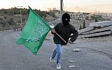 Un jeune de Jérusalem brandit le drapeau du Hamas (Nati Shohat/Flash90)