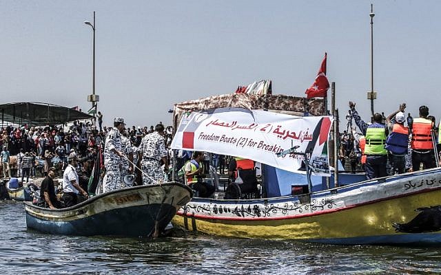 Des activistes escortent un bateau transportant des Palestiniens blessés lors d'affrontements le long de la barrière de sécurité de Gaza alors qu'il tente de franchir le blocus naval israélien du port de Gaza le 10 juillet 2018. (Crédit : Mahmud Hams / AFP)