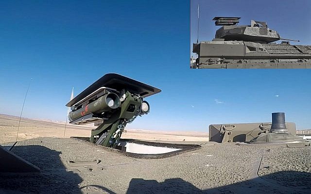 Un système de missile anti-chars sans pilote Spike est vu au sommet de la tourelle d'un véhicule de transport de troupes blindé Namer. (Crédit : ministère de la Défense)
