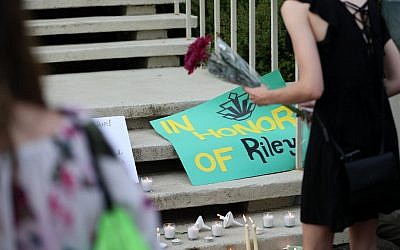 Des étudiants rendent hommage à Riley Howell, tué dans la fusillde l'univesité de Charlotte, en Caroline du nord, le 1er mai 2019. (Crédit : Logan Cyrus / AFP)