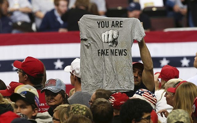 Photo d'illustration : Un supporter de Trump brandit un tee-shirt où il est écrit 'You Are Fake News' avant un rassemblement du président Donald Trump à Rochester, dans le Minnesota. (Crédit : AP Photo/Jim Mone, File)