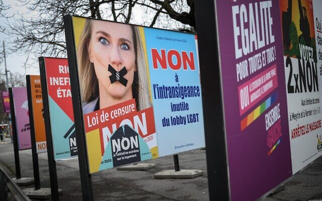 Une affiche de campagne sur laquelle figure une image de la députée suisse Céline Amaudruz, bâillonnée, qui demande aux électeurs suisses, lors d'un référendum, de rejeter une proposition d'interdiction de la discrimination fondée sur l'orientation sexuelle, sous prétexte qu'elle entraînerait une censure, sur un panneau d'affichage à Genève, le 30 janvier 2020.(Crédit Fabrice COFFRINI / AFP)