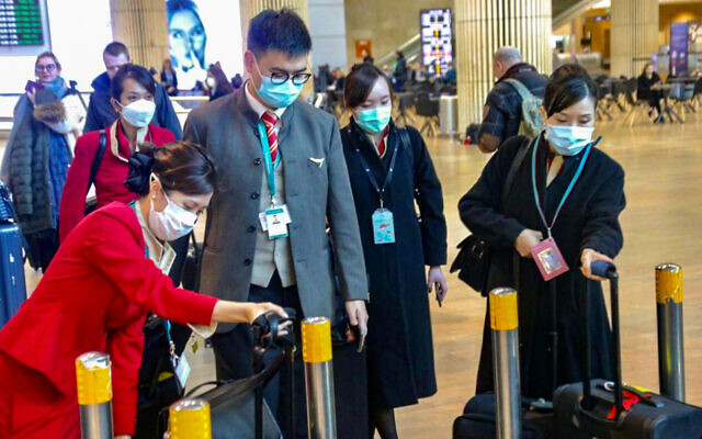 Des gens avec des masques sur le visage à l'aéroport international Ben Gurion suite aux  informations sur le coronavirus apparu en Chine et qui peut se propager dans le monde entier, le 17 février 2020 (Crédit :  Avshalom Shoshani/Flash90)