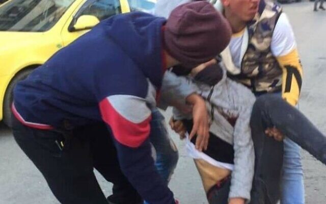 Deux Palestiniens traînent un adolescent hors de la scène d'un affrontement après avoir été touché par les soldats de l'armée israélienne à Hébron, le 5 février 2020. (Autorisation)