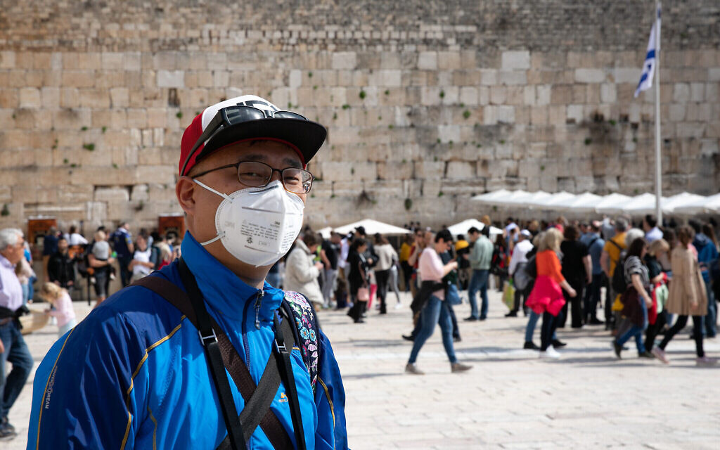 Un touriste porte un masque de protection contre le coronavirus lors de sa visite du mur Occidental dans la Vieille Ville de Jérusalem, le 27 février 2020. (Olivier Fitoussi/Flash90)