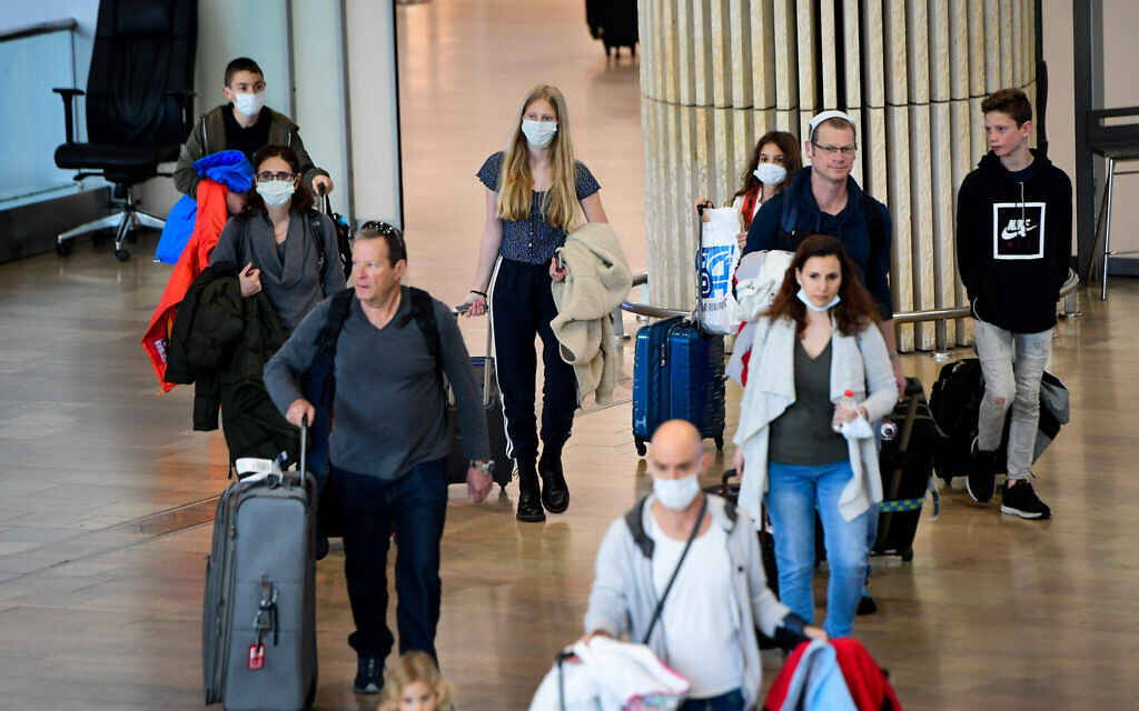 Des personnes portant des masques de protection par crainte du coronavirus arrivent à l'aéroport international Ben Gurion, le 10 mars 2020. (Avshalom Sassoni/Flash90)