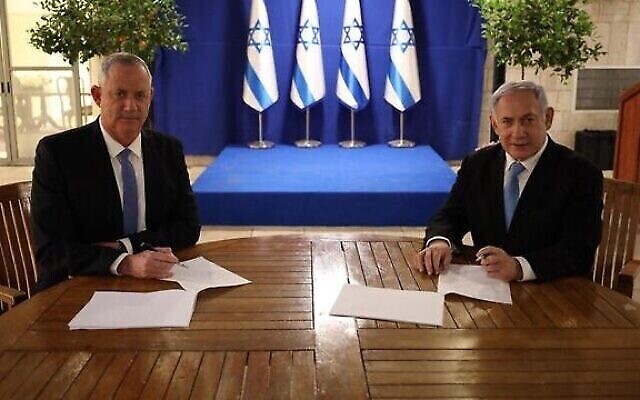 Benny Gantz (à gauche), le dirigeant de Kakhol lavan, et Benjamin Netanyahu, le Premier ministre, signent leur accord de gouvernement d'union, le 20 avril 2020. (Crédit : GPO)