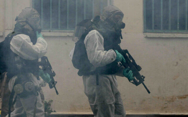 Des soldats de Tsahal en combinaison de protection chimique organisent un exercice simulant une attaque chimique dans le cadre d'un exercice national de défense civile à Ramat Gan, près de Tel Aviv, le 20 mars 2007. (Roni Schutzer/Flash90)
