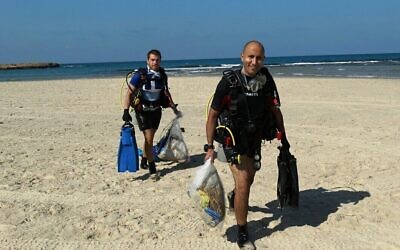 Des plongeurs volontaires aident à collecter des ordures de la mer méditerranée. (Crédit : Dov Greenblatt, Société pour la protection de la nature en Israël)
