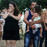 Les habitants  en état de choc après qu'une roquette a heurté une maison dans la côte d'Ashkelon tôt le matin du 26 août 2014, pendant l'Opération Bordure Protectrice - une guerre entre Gaza et Israël. (Edi Israël / Flash90)