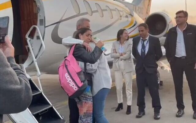 Mordy et Natali Oknin enlacent leur fille Shiraz après leur retour en Israël le 18 novembre 2021. (Capture d'écran/Autorité aéroportuaire d'Israël)