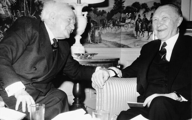 Le Premier ministre David Ben-Gourion, à gauche, pose une main sur le bras du chancelier ouest-allemand Konrad Adenauer lors de leur rencontre à l'hôtel Waldorf-Astoria de New York, le 14 mars 1960.  (Crédit : AP Photo)