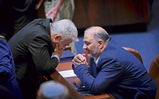 Le ministre des Affaires étrangères Yair Lapid et le leader du parti Raam, Mansour Abbas, à la Knesset, le 21 juin 2021. (Crédit : Olivier Fitoussi/FLASH90)