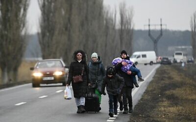 Des réfugiés ukrainiens, après avoir traversé le point de contrôle de la frontière moldo-ukrainienne à proximité de la ville de Palanca, le 1er mars 2022.
(Crédit : Nikolay DOYCHINOV / AFP)