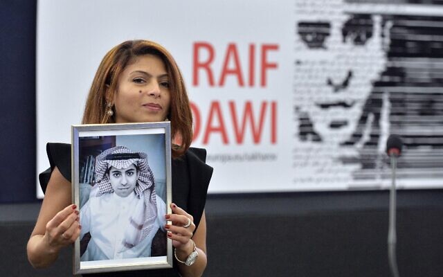 Sur cette photo d'archives prise le 16 décembre 2015, Ensaf Haidar tient une photo de son mari Raif Badawi après avoir accepté le prix Sakharov des droits de l'homme du Parlement européen au nom de son mari, au Parlement européen à Strasbourg, dans l'est de la France. (Crédit : Patrick Hertzog/AFP)