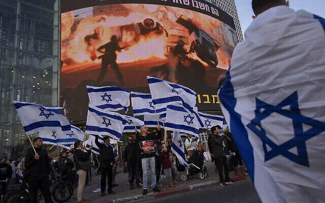 Right wing activists wave Israeli flags during a protest against Israel's Prime Minister Naftali Bennett, following a recent wave of violence, in Tel Aviv, Israel, Wednesday, March 30, 2022. Three deadly attacks in Israel in a week are raising questions over Israel's approach to its conflict with the Palestinians, after years of efforts to sideline the issue and focus instead on other regional priorities.(AP Photo/Oded Balilty)