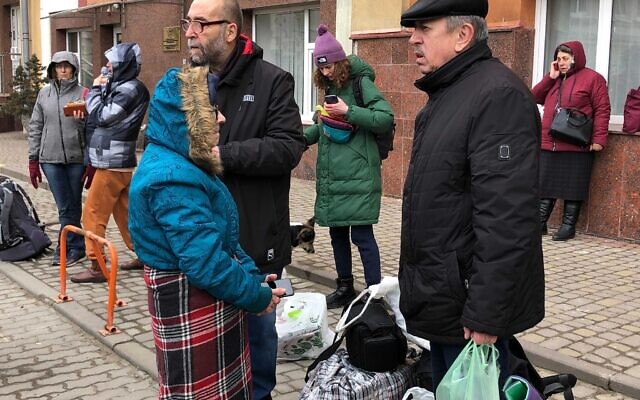 Des Israéliens et leurs proches attendent un "bus de secours" qui les emmènera de Lviv jusque de l'autre côté de la frontière polonaise pour quitter l'Ukraine en guerre, le 2 mars 2022. (Crédit : Lazar Berman/The Times of Israel)