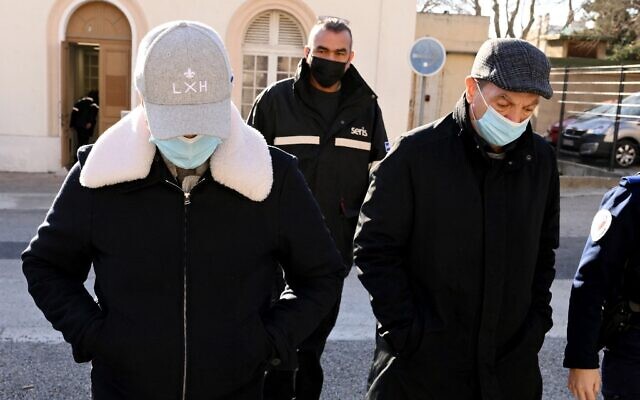 Les dentistes français Lionel et son père Carnot Guedj, accusés d'escroquerie et de mutilation dentaire, arrivent au palais de justice au premier jour de leur procès à Marseille, dans le sud de la France, le 28 février 2022. (Crédit : Nicolas TUCAT / AFP)
