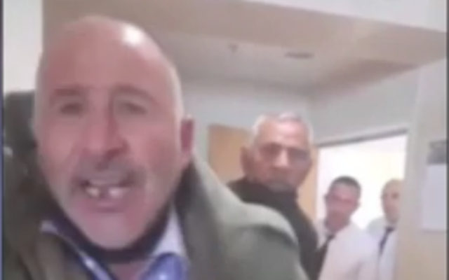 Photo de la vidéo de Khaled Abu Jaudah, dont le fils a été condamné pour avoir tué un soldat de Tsahal lors d'une attaque terroriste, accostant le père de la victime au tribunal de district de Beer Sheva, le 27 avril 2022. (Crédit : Capture d'écran/Douzième chaîne)