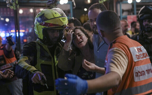 Une femme réagit sur les lieux d’un attentat terroriste à Tel Aviv, Israël, le jeudi 7 avril 2022 (Crédit : AP Photo/Ariel Schalit).