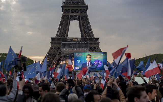 Le président français Emmanuel Macron avec ses partisans devant la Tour Eiffel à Paris, au soir de sa victoire, le 24 avril 2022. (Crédit : AP Photo/Rafael Yaghobzadeh)