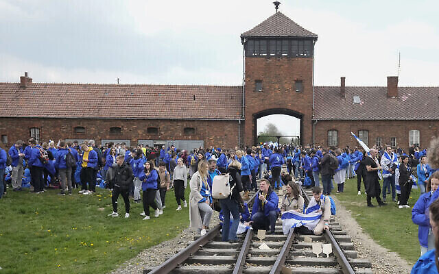 Des Juifs visitent le camp de concentration nazi d'Auschwitz après la Marche des vivants, qui n'a pas eu lieu pendant deux ans en raison de la pandémie mondiale de COVID-19, à Oswiecim, en Pologne, le 28 avril 2022. (Crédit : AP Photo/Czarek Sokolowski)