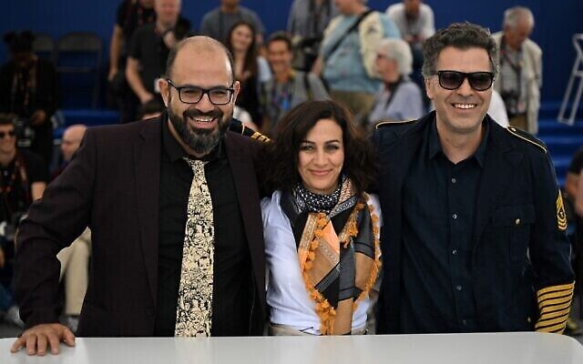L’acteur arabo-israélien Amer Hlehel, le réalisateur arabo-israélien Maha Haj et l’acteur arabo-israélien Ashraf Farah se livrent à une séance de photo pour le film "Fièvre méditerranéenne" lors de la 75e édition du Festival de Cannes, dans le sud de la France, le 25 mai 2022. (Crédit : Patricia De Melo Moreira/AFP)