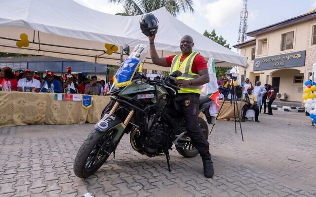 Kunle Adeyanju arrive au Rotary club d'Ikeja à Lagos le 29 mai 2022, après un voyage de 41 jours depuis Londres, en moto, pour collecter des fonds et sensibiliser le public à la campagne "End Polio". (Crédit : Benson Ibeabuchi / AFP)
