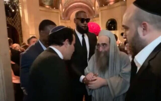 LeBron James tient la main du rabbin Yoshiyahu Yosef Pinto lors du mariage de Jeffrey Schottenstein à New York, le 22 mai 2022. (Crédit : Capture d'écran/YouTube/Jewish Insider)