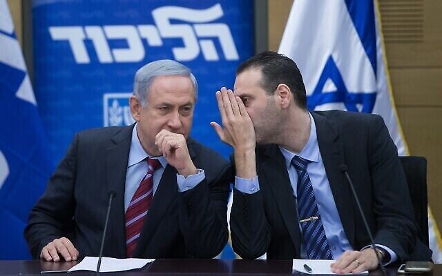 Le Premier ministre de l’époque, Benjamin Netanyahu, à gauche, s’entretient avec le député Miki Zohar lors d’une réunion de la faction du Likud à la Knesset, le 25 janvier 2016. (Crédit : Yonatan Sindel/Flash90)