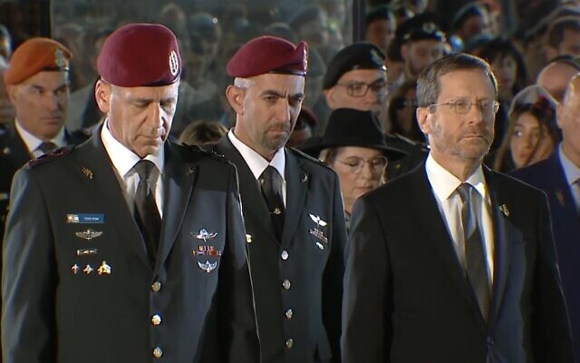 Le chef d'État-major Aviv Kohavi, à gauche, et le président Isaac Herzog, à droite, pendant la minute de silence lors de la cérémonie d'État organisée pour Yom HaZikaron, en hommage aux soldats tués au combat, au mur Occidental de Jérusalem, le 3 mai 2022. (Capture d'écran/Vidéo)