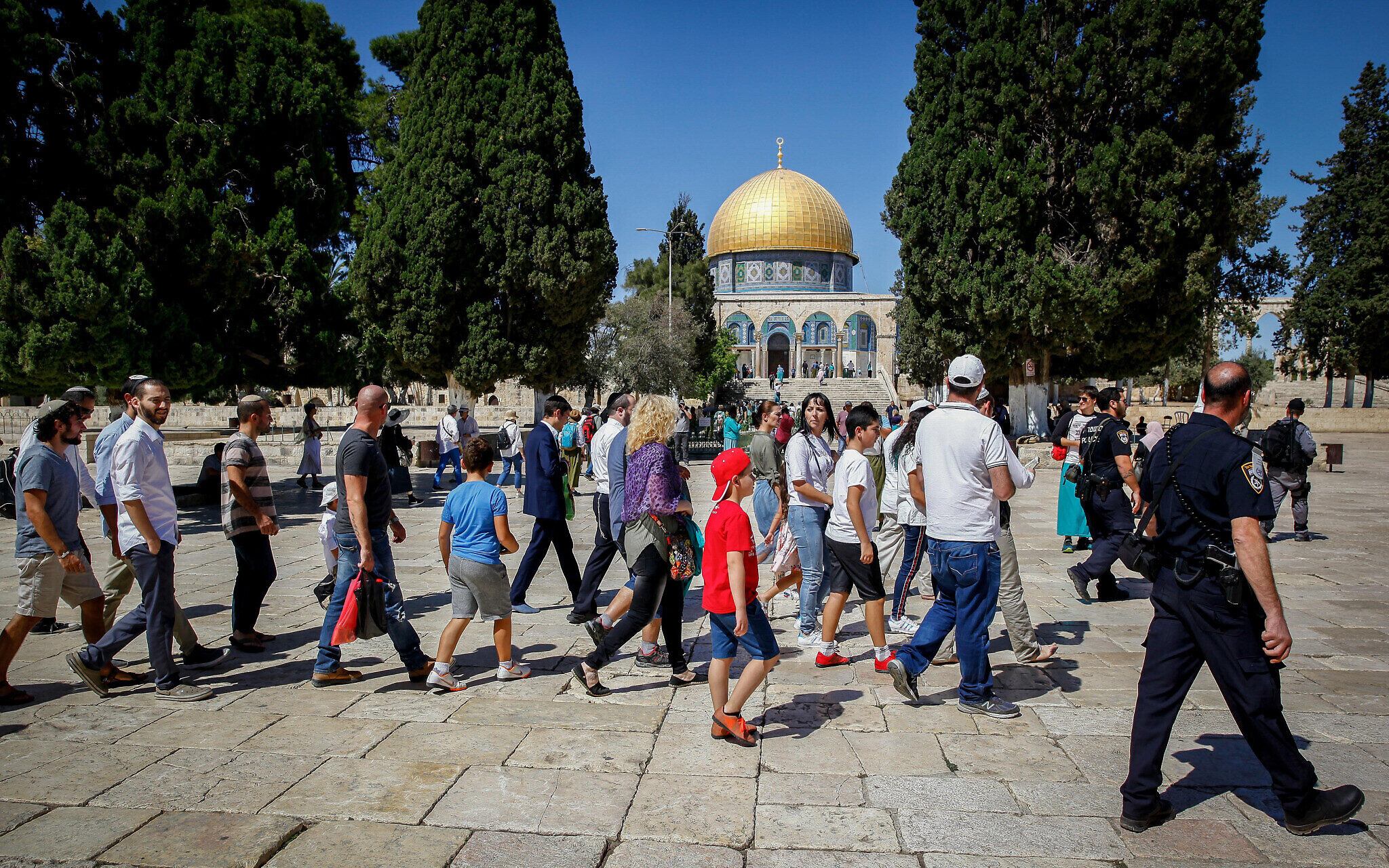 Des Juifs religieux escortés par la police sur le mont du Temple, dans la Vieille Ville de Jérusalem, pendant la fête de Soukkot, le 24 septembre 2018. (Crédit : Sliman Khader/Flash90)