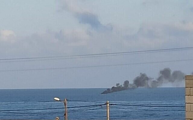 De la fumée s’élève d’un navire soupçonné de contrebande, au large de la bande de Gaza, après une ouverture de feu par la Marine israélienne. (Crédit : Réseaux sociaux)