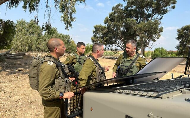 Le chef militaire Aviv Kohavi (à droite) s'entretient avec des responsables près de la frontière avec la bande de Gaza, le 4 août 2022. (Crédit : Armée israélienne)