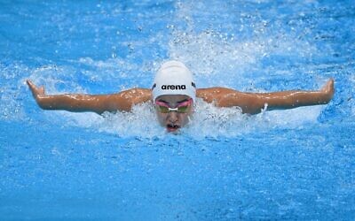 Yusra Mardini, de l'équipe olympique des réfugiés, participe à une manche de l'épreuve de natation féminine du 100 m papillon lors des Jeux olympiques de Tokyo 2020 au Centre aquatique de Tokyo, le 24 juillet 2021. (Crédit : Oli SCARFF / AFP)