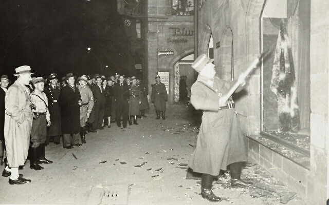 Des nazis et des civils allemands assistent au saccage de biens juifs pendant la Nuit de Cristal, probablement dans la ville de Fürth, en Allemagne, le 10 novembre 1938. (Crédit : Yad Vashem via AP)