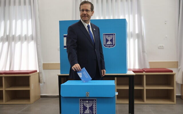 Le président israélien Isaac Herzog vote lors des élections générales israéliennes, dans un bureau de vote à Jérusalem,le 1er novembre 2022. (Crédit : Yonatan Sindel/Flash90