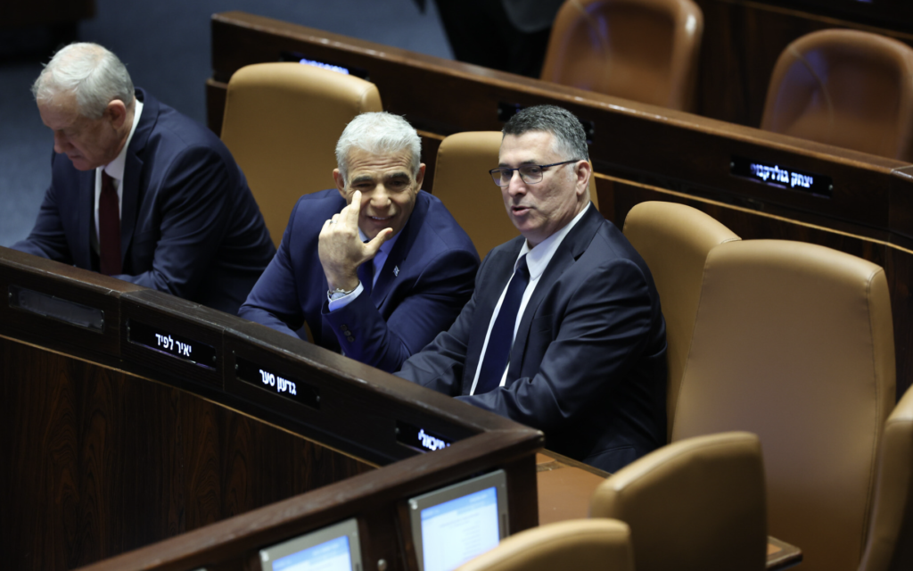 Le ministre sortant de la Justice, Gideon Saar, à droite, et le Premier ministre sortant, Yaïr Lapid, lors de la cérémonie de prestation de serment du nouveau gouvernement Netanyahu, à la Knesset, le 29 décembre 2022. (Crédit : Yonatan Sindel/FLASH90)
