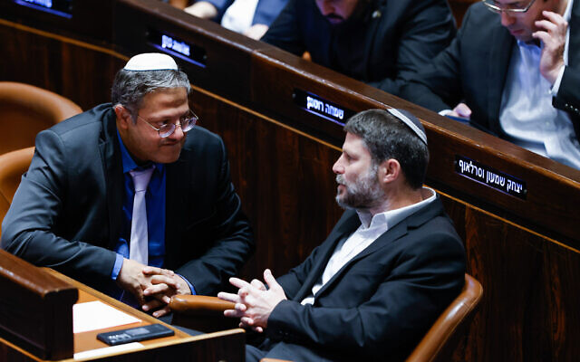 Le dirigeant d’Otzma Yehudit, Itamar Ben Gvir, à gauche, s’entretenant avec le chef de HaTzionout HaDatit Bezalel Smotrich, à la Knesset, le 29 décembre 2022. (Crédit : Yonatan Sindel/Flash90)
