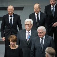 Le président allemand Frank-Walter Steinmeier (en bas à droite) avec son épouse Elke Buedenbender (en bas à gauche), Klaus Schirdewahn, représentant de la communauté queer (au centre), et le chancelier allemand Olaf Scholz (en haut au centre), à la cérémonie annuelle à la mémoire des victimes de l'Holocauste dans la salle plénière du Bundestag, la chambre basse du parlement allemand, à Berlin, le 27 janvier 2023, à l'occasion de la Journée internationale de commémoration de l'Holocauste. (Crédit : STEFANIE LOOS / AFP)