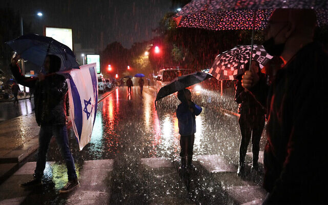 Des manifestants israéliens brandissent des pancartes lors d'un rassemblement contre le nouveau gouvernement d'extrême droite du Premier ministre Benjamin Netanyahu dans la ville côtière de Tel Aviv le 14 janvier 2023. (Crédit : AP)