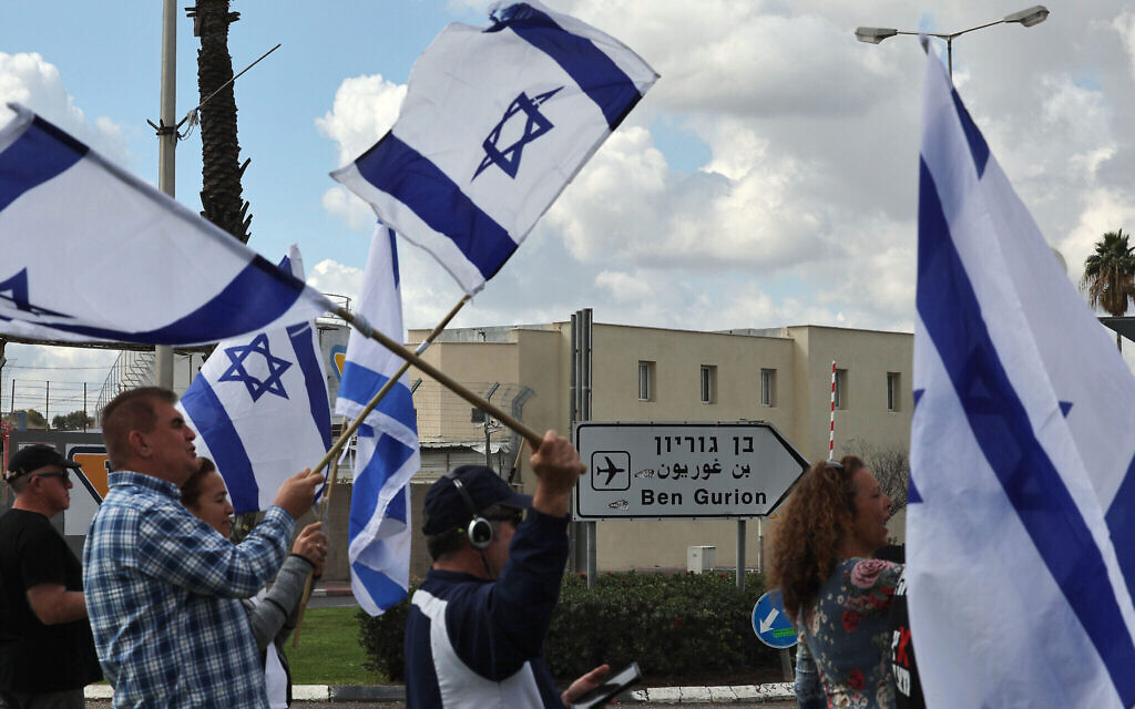Des Israéliens protestant contre la réforme du système judiciaire du gouvernement, à l'une des entrées de l'aéroport Ben Gurion, le 9 mars 2023. (Crédit : Ahmad Gharabli/AFP)