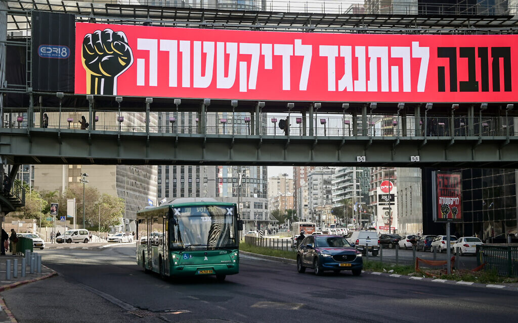 "Obligés de s'opposer à la dictature", lit-on sur la bannière contre la refonte judiciaire prévue par le gouvernement israélien, à Ramat Gan, le 8 mars 2023. 
 (Crédit : Avshalom Sassoni/Flash90)
