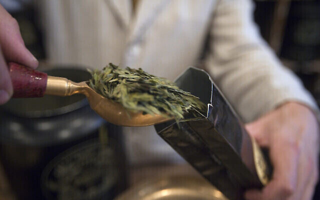 Un vendeur met en sachet du thé vert au comptoir de la maison de thé de luxe française Mariage Frères, le 10 octobre 2011, dans le Marais, à Paris. (Crédit : Joel Saget/AFP)