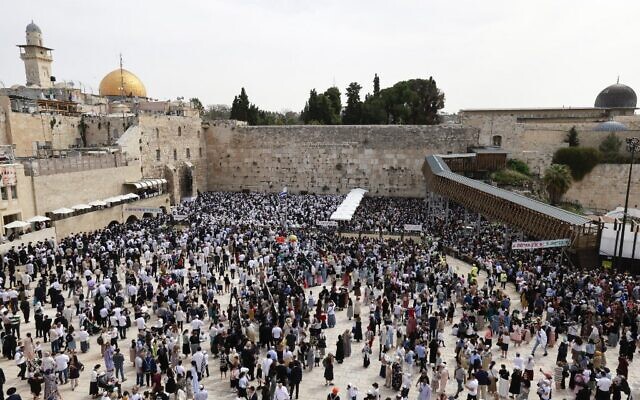 Des Juifs, portant le châle de prière traditionnel, prennent part à la béndiction des Cohanim (bénédiction des prêtres) au mur Occidental, pendant Pessah, le 9 avril 2023. (Crédit : Menahem KAHANA / AFP)