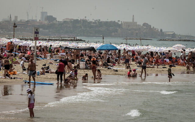 Des gens profitant de la plage à Tel Aviv, pendant Pessah, le 9 avril 2023. (Crédit : Avshalom Sassoni/Flash90)